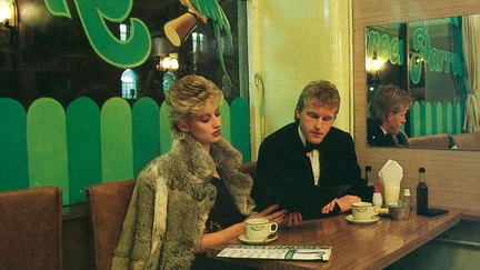 Interior of The Green Parrot restaurant in 1985, featuring a couple seated dressed for a night out