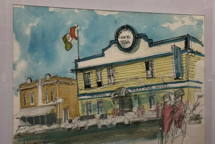 A photo of a painting showing the outside of La Petite Artisan Chocolate.