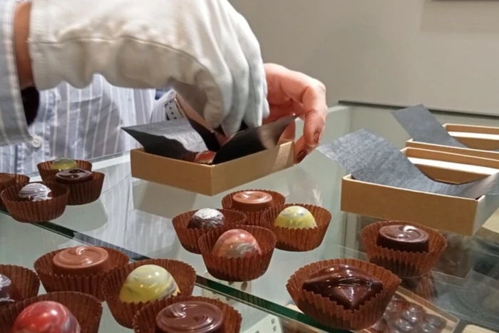 Photo of hands making chocolate.