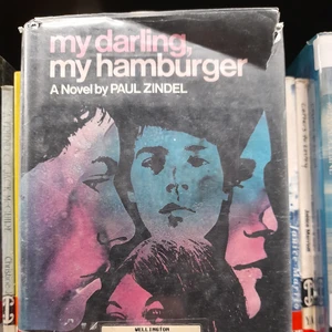 Book cover "My Darling, my Hamburger" by Paul Zindel. Cover image is of four faces drawn in black over a blue and pink sky.