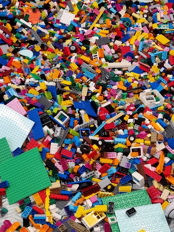 A huge pile of LEGO pieces of various shapes, sizes and colours.