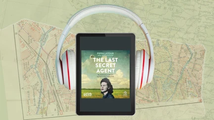 The Last Secret Agent cover (a woman in front of a field), displayed on an ebook with headphones.