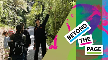 On the right, the Beyond the Page logo. On the left, a photo. A track through the bush, a group following a Zealandia educator who gestures up towards a tree to the right.