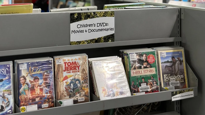Face-out library shelving displaying children's DVDs