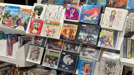 Face-out library shelving displaying children's audiobooks on CD