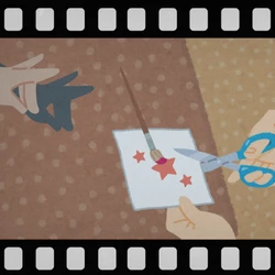 A film negative style border around an image of a shadow puppet and a hand cutting stars out of paper