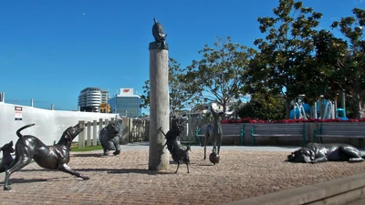 Sculpture in Tauranga. Scarface Claw perches on top of a pole, while Hairy Maclary and friends peer upwards