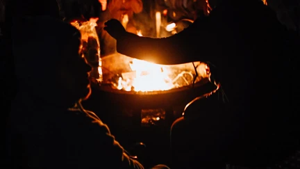 People gathered around a fire outside