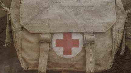 An army kit bag emblazoned with the medical red cross