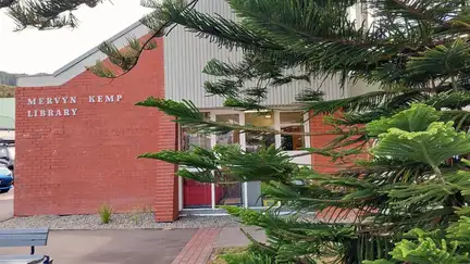 Exterior of Tawa Library, a red brick building with a tree outside