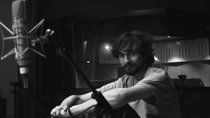 Black and white photo on Toby in a recording studio.